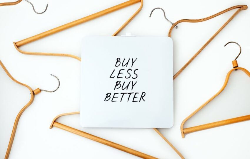 Brown hangers with text that says buy less buy better