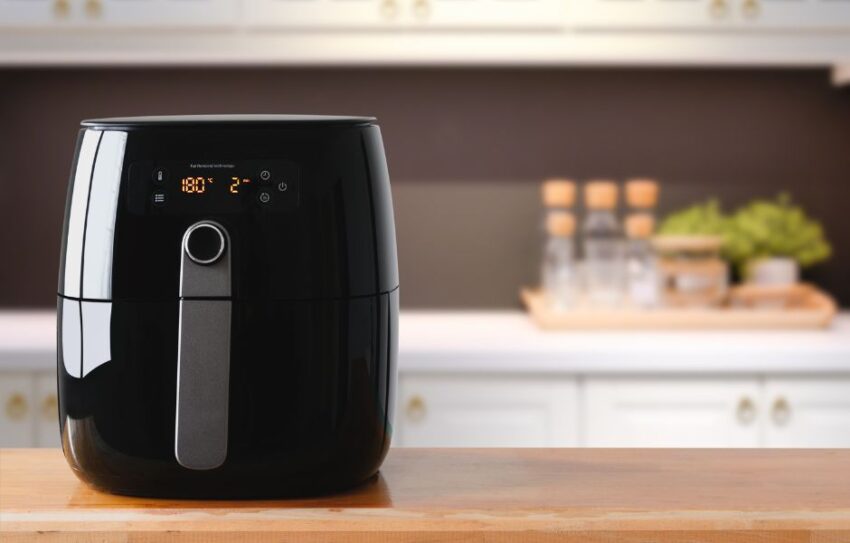 A black air fryer on a kitchen worktop