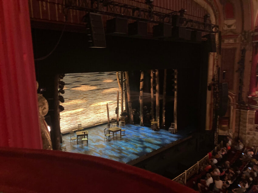 An ariel view of a stage with some wooden furniture placed across it.