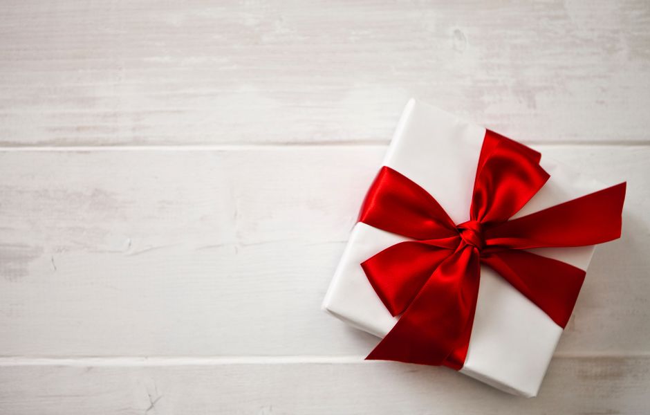 A white gift with a red bow